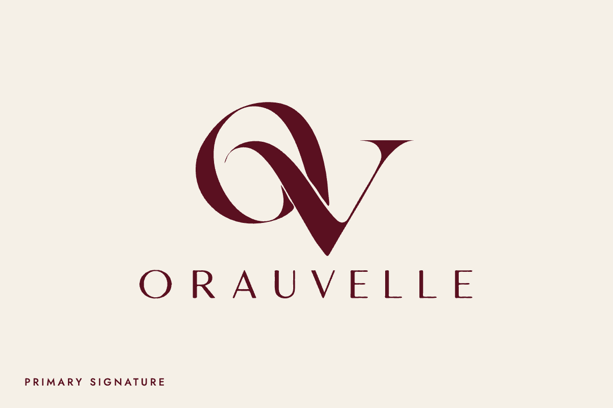 The Orauvelle signature: a woven OV monogram above the name, burgundy on ivory