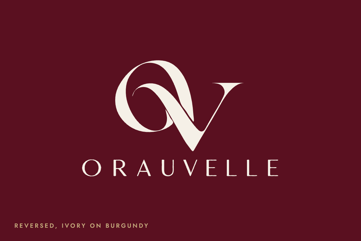 Orauvelle signature reversed in ivory on house burgundy